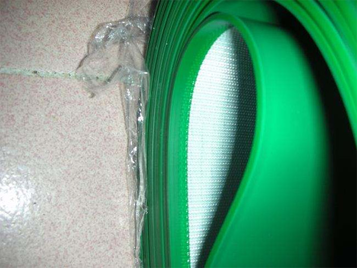 Why do PVC conveyor belts need edge wrapping?